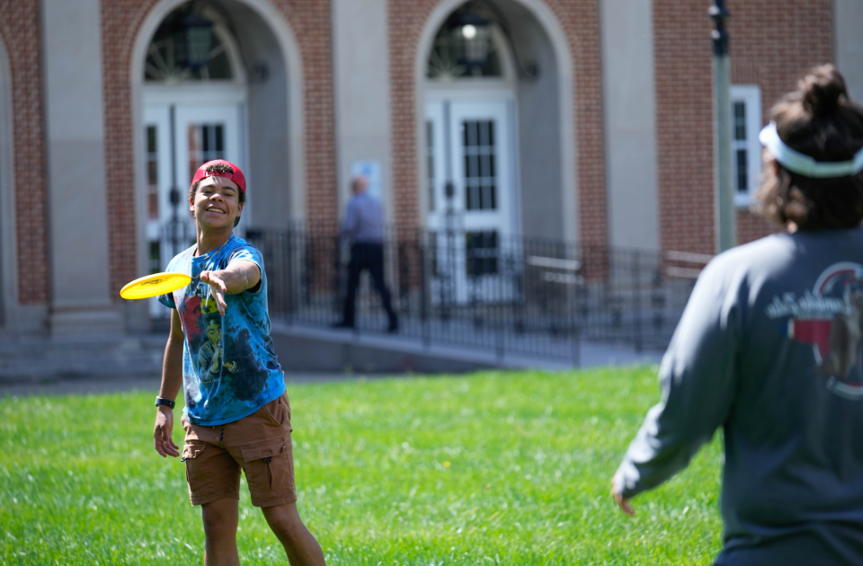 A group of students playing frisbee.